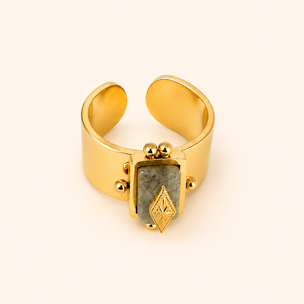 Celeste Artisan adjustable statement 14K gold plated ring with geometric stone design on a light beige background