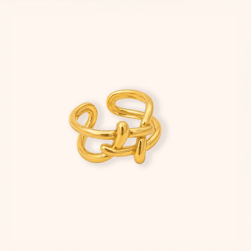 A 18K gold-toned abstract interlocking ring with a polished finish, centered on a clean off-white background.