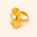 18K Gold plated pearl flower cocktail ring with a pearl on a light beige background