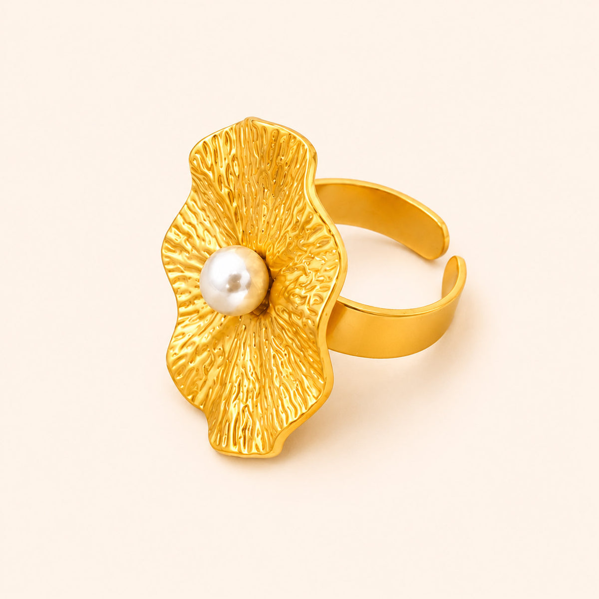 18K Gold plated pearl flower cocktail ring with a pearl on a light beige background