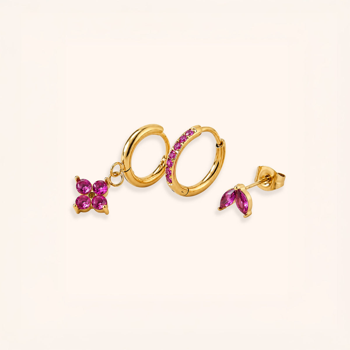 18K Gold plated set of 3 earrings set with pink gemstones on a white background by the Wish Store.