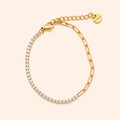 Gold bracelet with CZ stones on a beige background