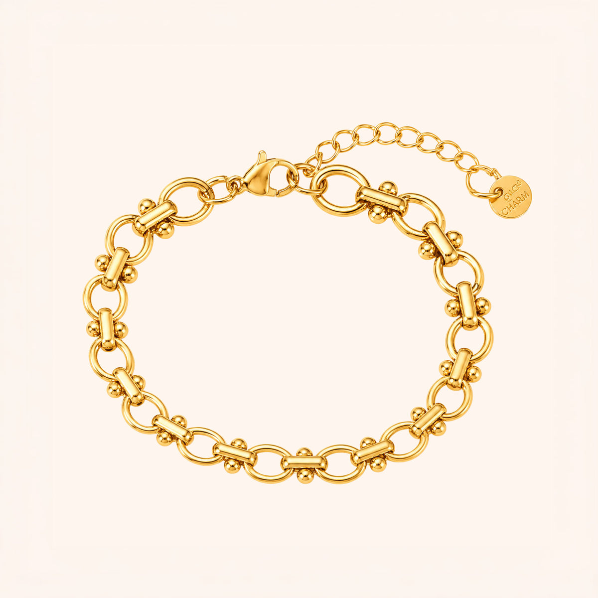Gold chain bracelet on a light beige background