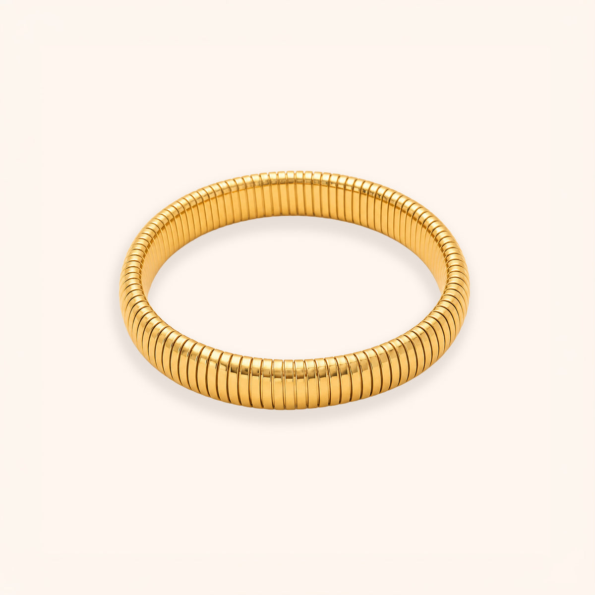 A gold-colored segmented bangle bracelet with a textured, ribbed design, displayed on a clean off-white background.