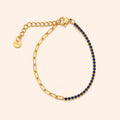 Gold bracelet with blue stones on a beige background