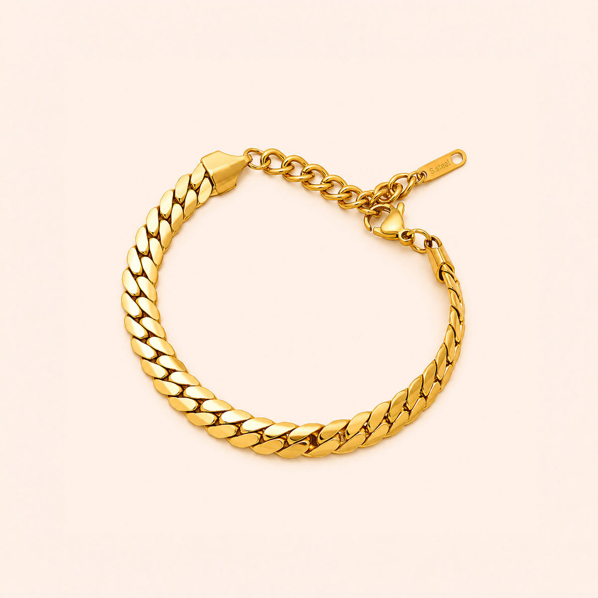 A gold-toned metal chain bracelet with a curb-style link design, displayed on a light cream background.