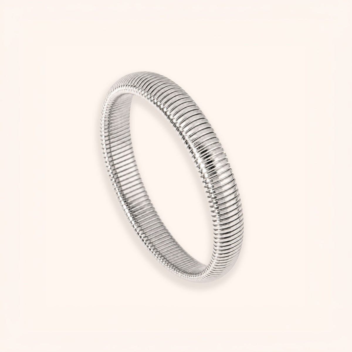 A bold silver-toned bangle bracelet with a textured, ridged snake-like pattern, shown on a light cream background.