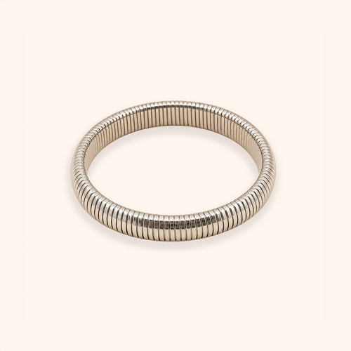 A silver-toned metal bangle bracelet with a textured, ribbed snake-skin style pattern, shown on a plain light beige background.
